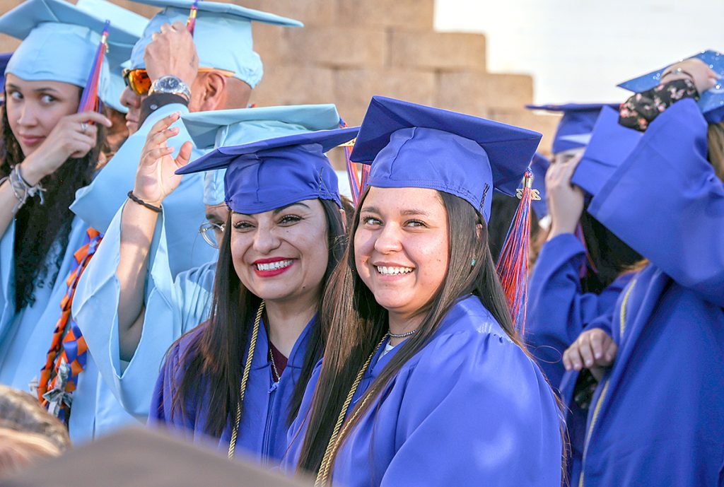 Photo of smiling graduates at commencement ceremony