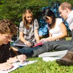 4 students study on lawn