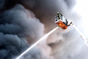 A fire fighter at work in a hydraulic hoist