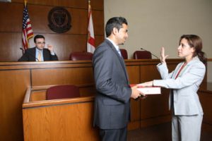 Woman being sworn in at court