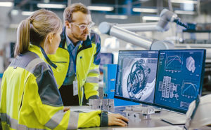 Photo of engineers working on gear design on computer