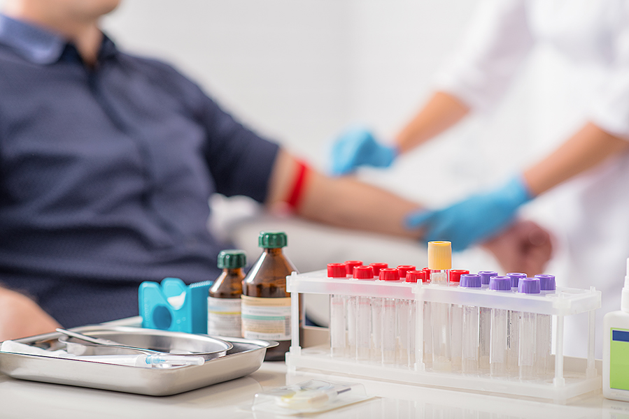 Photo of man getting blood test preparation in clinic
