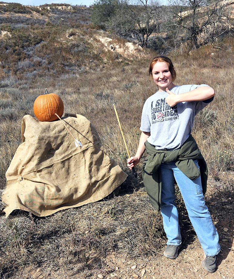 Photo of Kristine Newman with the pumpkin target