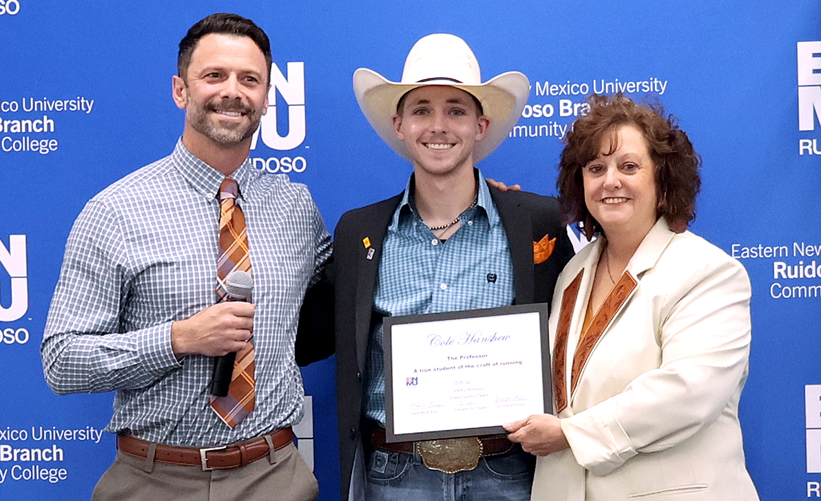 Cross Country Coach Micah Bray with Cole Hanshew and Interim Athletic Coordinator Sharon Young