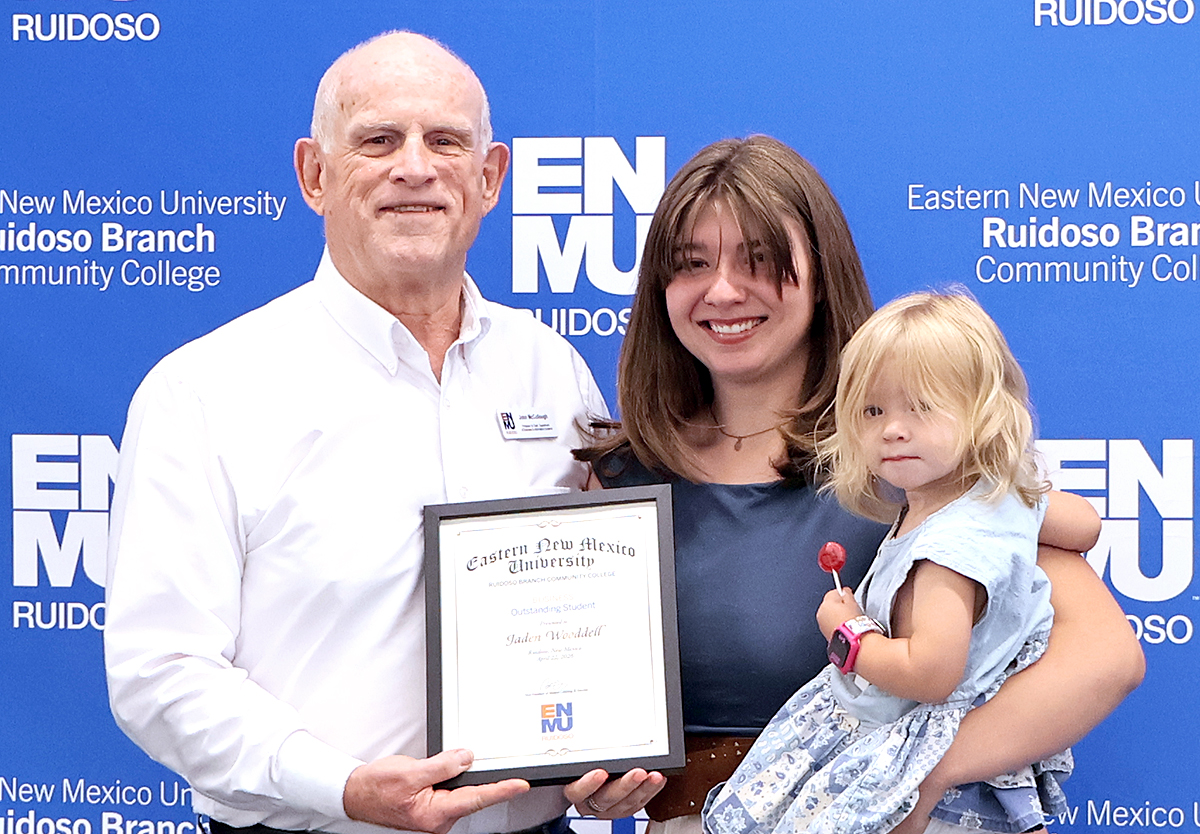 Photo of Business Department Chair John McCullough with Jaden Wooddell and her young daughter at awards ceremony, April 22, 2026