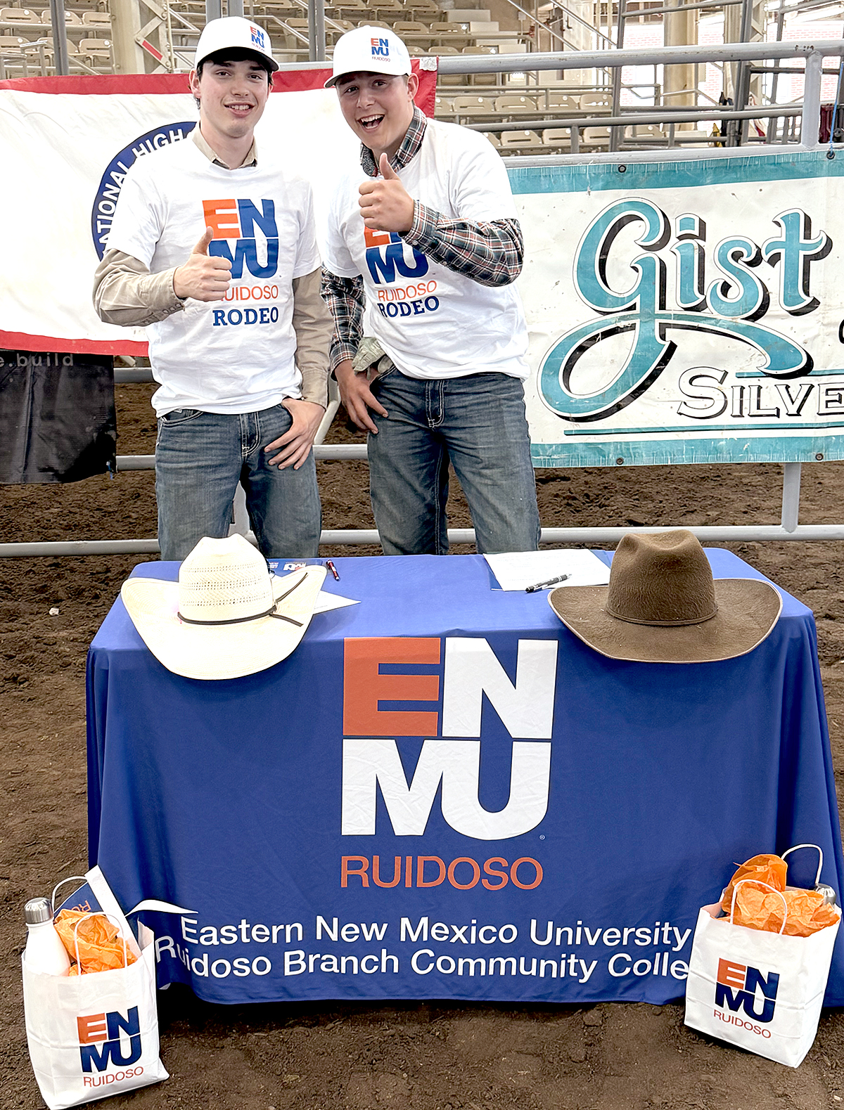 Photo of Walker Hanafin and Eli Foster wearing ENMU-Ruidoso branded shirts and hats