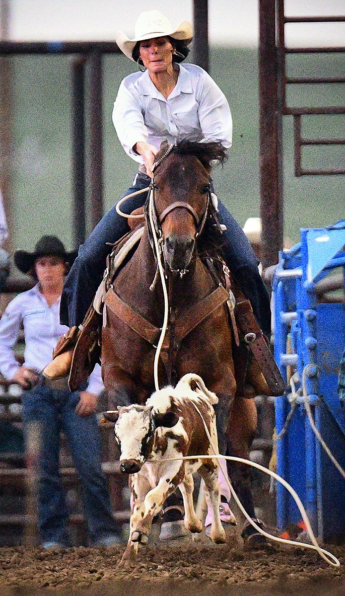 Photo of Randa Clabaugh on horse during calf roping competition at rodeo