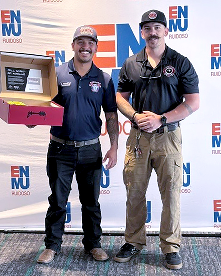 Photo of firefighter Blake Templeton holding Wolverine gift box and Lt. Alec Davis of Ruidoso Fire Department.